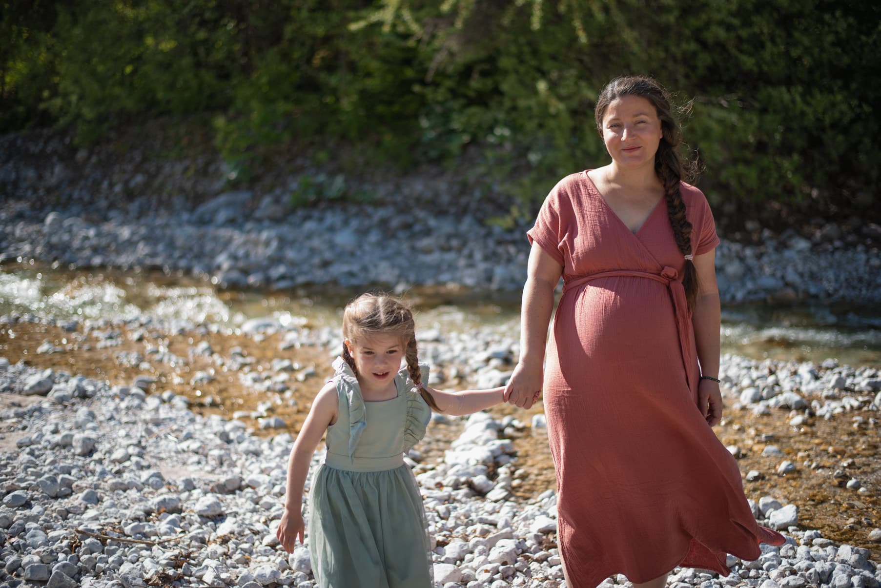 Become a more relaxed mother with hypnotherapy for health anxiety why do I panic every time my child gets sick ? Pregnant mother walking with her young daughter, representing becoming a calmer parent with hypnotherapy for health anxiety.